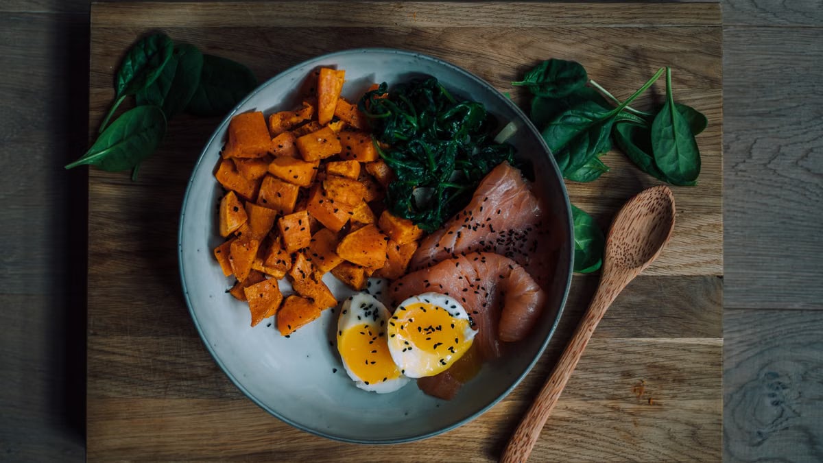 Delicious and nutritious meal featuring salmon, sweet potato, and eggs, perfect for a healthy diet.